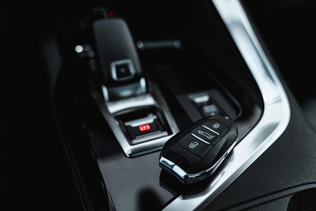 Close-up of modern car interior featuring a sleek car key and shifter, showcasing luxury design.